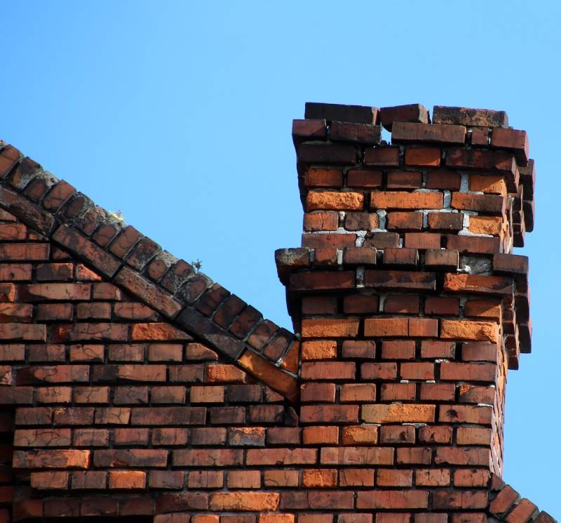 Signs Your Cary Home Needs a Chimney Inspection Damaged chimney on an Cary home showing cracks and missing mortar